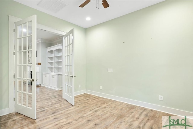 unfurnished room featuring wood finished floors, baseboards, visible vents, ceiling fan, and french doors