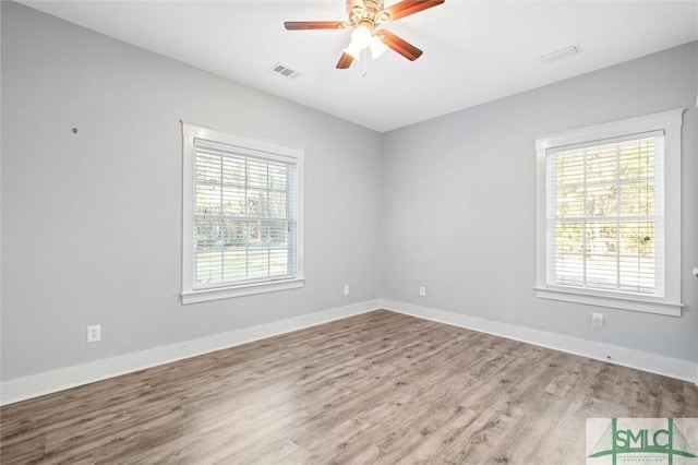 empty room with visible vents, ceiling fan, and baseboards