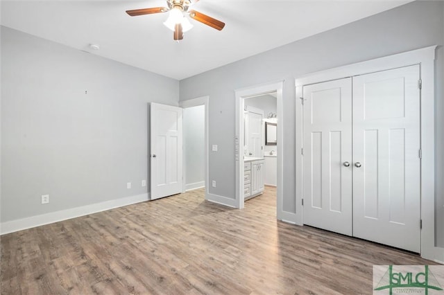 unfurnished bedroom with baseboards, ceiling fan, light wood-style flooring, ensuite bathroom, and a closet