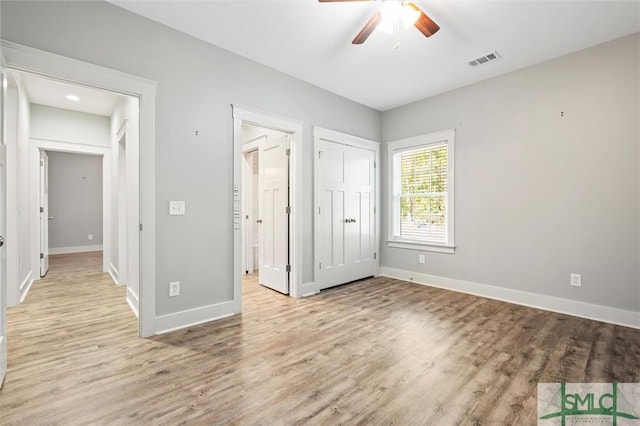 unfurnished bedroom with light wood-style flooring, baseboards, and visible vents