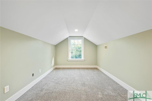 bonus room featuring visible vents, carpet, baseboards, and vaulted ceiling