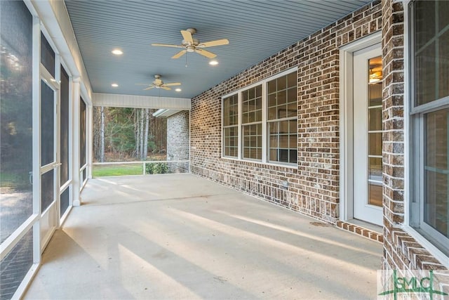 unfurnished sunroom with a ceiling fan