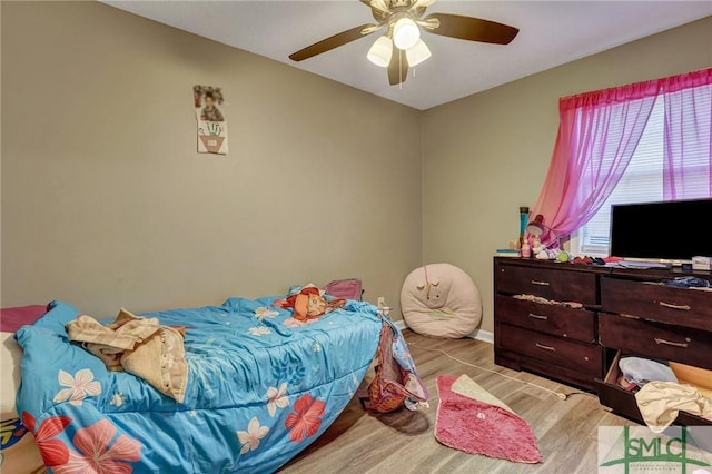 bedroom with ceiling fan, baseboards, and wood finished floors