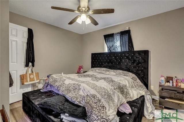 bedroom featuring ceiling fan and wood finished floors