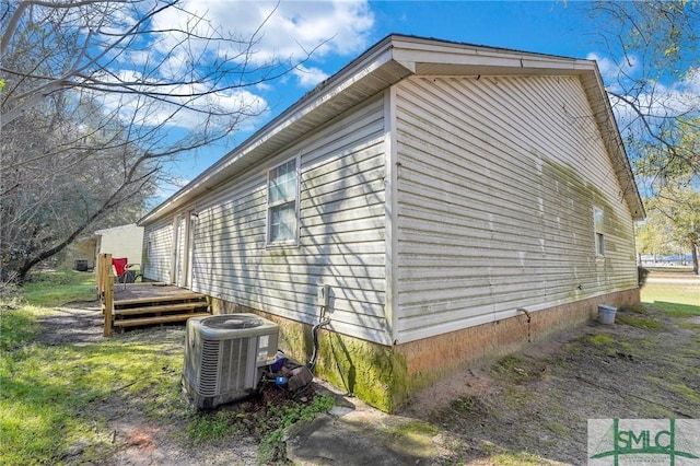 view of home's exterior with central air condition unit and a wooden deck