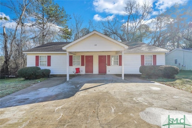 single story home featuring concrete driveway