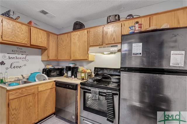 kitchen featuring visible vents, under cabinet range hood, light countertops, appliances with stainless steel finishes, and a textured ceiling