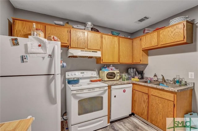 kitchen featuring visible vents, under cabinet range hood, a sink, white appliances, and light countertops