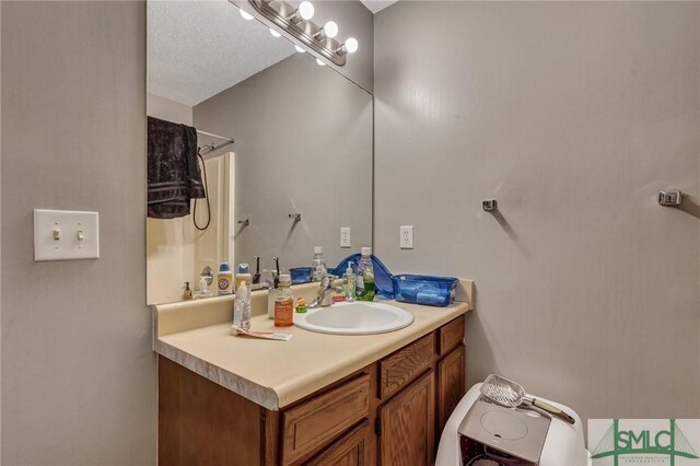 full bath with a shower and vanity