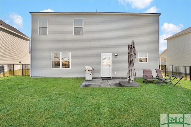 back of house featuring a patio area, a yard, and fence