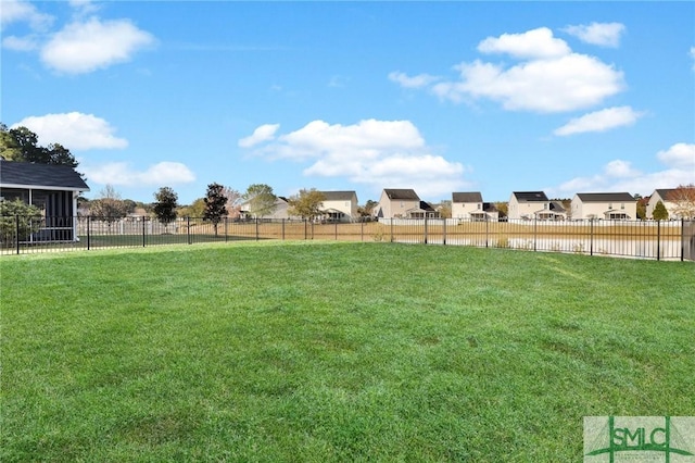 view of yard with a residential view and fence