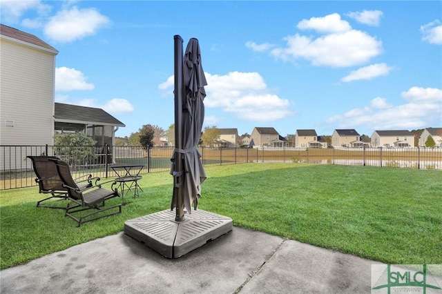 view of yard with a patio area, a residential view, and fence