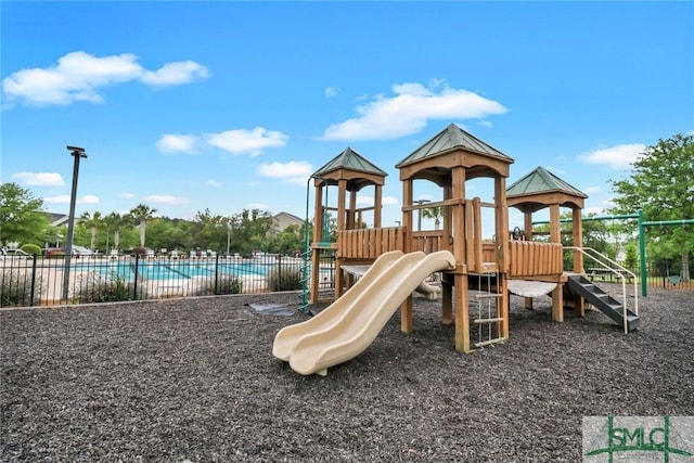 community play area featuring fence and a community pool