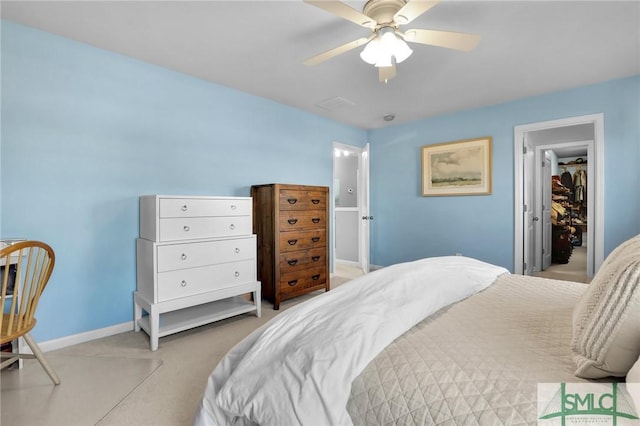 carpeted bedroom with a ceiling fan and baseboards