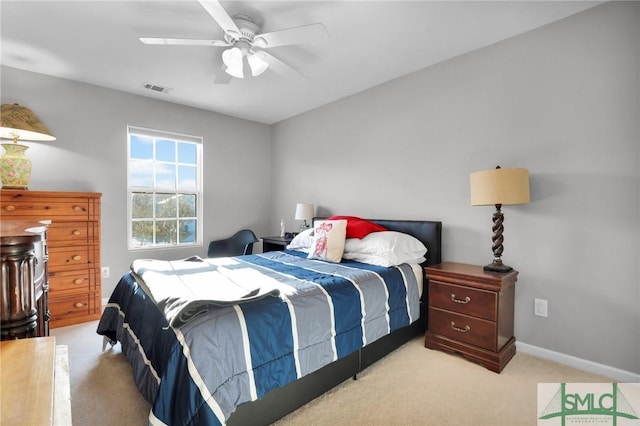 carpeted bedroom with a ceiling fan, baseboards, and visible vents