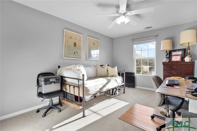 bedroom featuring visible vents, light colored carpet, baseboards, and ceiling fan