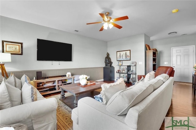 living area featuring wood finished floors and ceiling fan