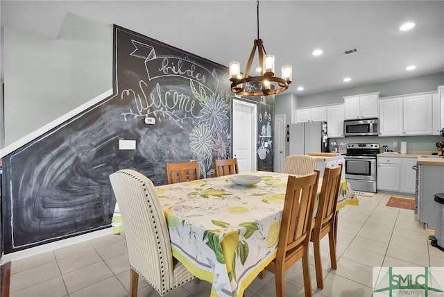 dining space featuring light tile patterned flooring, recessed lighting, visible vents, and a chandelier