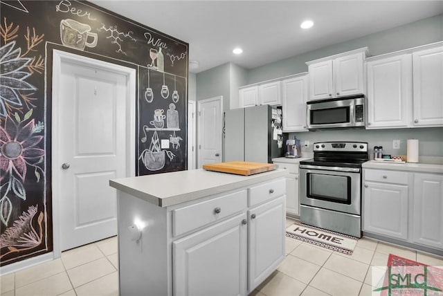 kitchen featuring stainless steel appliances, white cabinetry, light tile patterned flooring, and light countertops