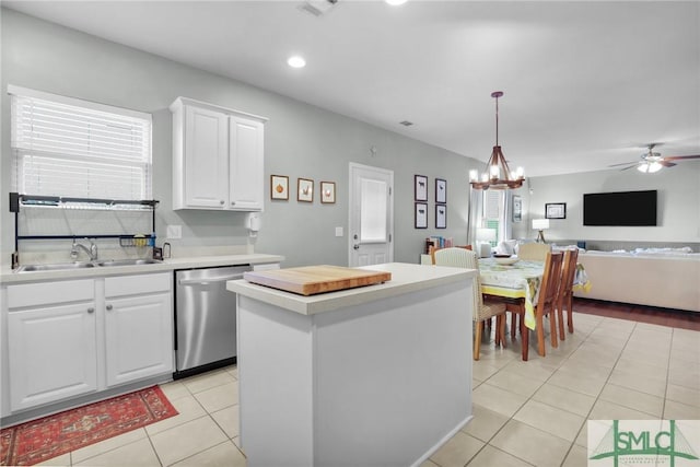 kitchen featuring a sink, a center island, light tile patterned flooring, light countertops, and dishwasher