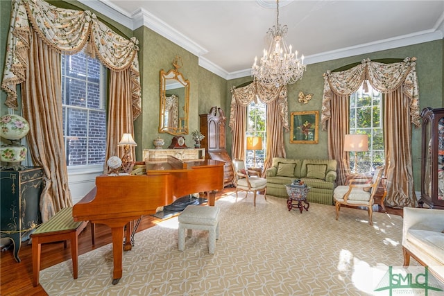 sitting room with an inviting chandelier, crown molding, and wood finished floors