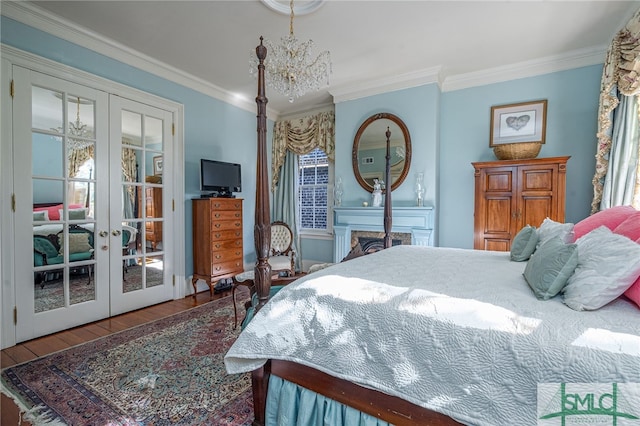 bedroom featuring french doors, crown molding, an inviting chandelier, and wood finished floors