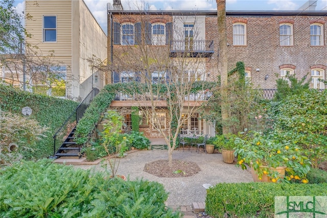 view of property's community featuring stairway and a patio area