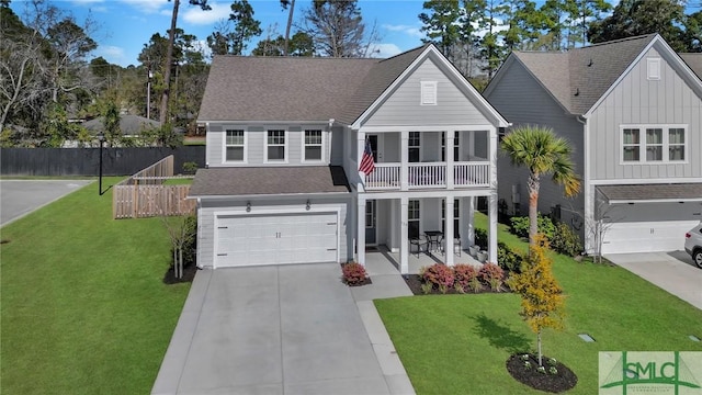 traditional home with a front lawn, covered porch, a balcony, a garage, and driveway