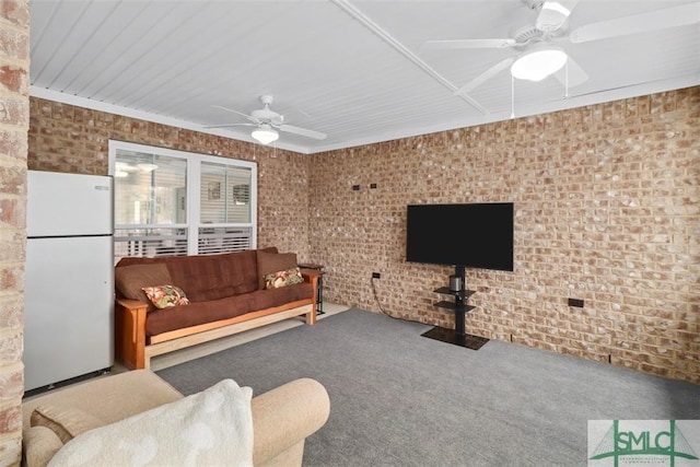 carpeted living room with brick wall and ceiling fan