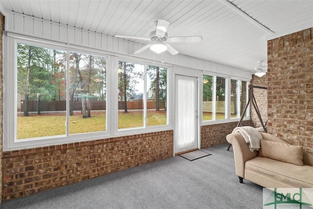 unfurnished sunroom with ceiling fan