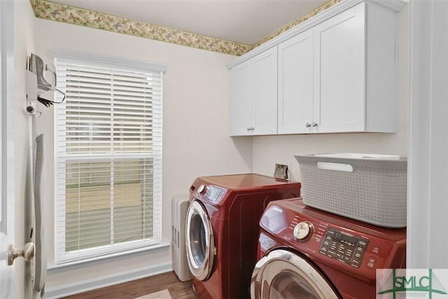 clothes washing area with cabinet space, independent washer and dryer, and wood finished floors