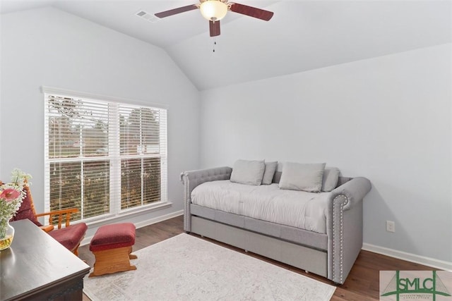 bedroom featuring visible vents, wood finished floors, baseboards, and vaulted ceiling