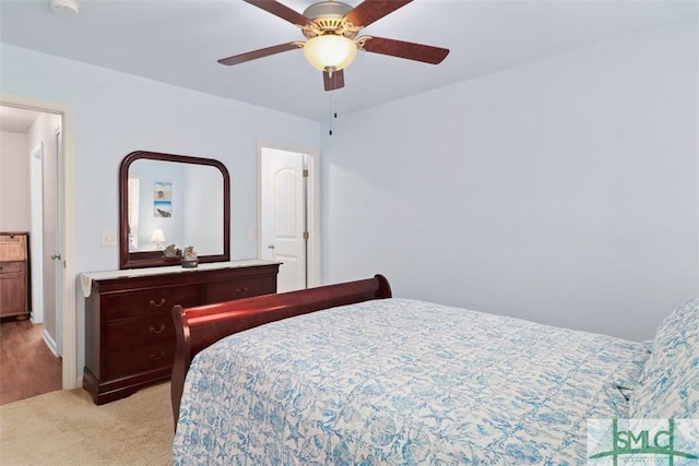 bedroom featuring light carpet and ceiling fan