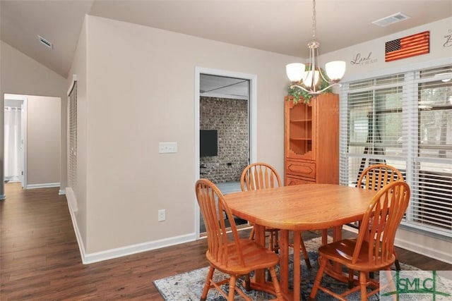 dining room with a notable chandelier, dark wood-style floors, visible vents, and baseboards