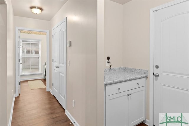 interior space with baseboards and wood finished floors