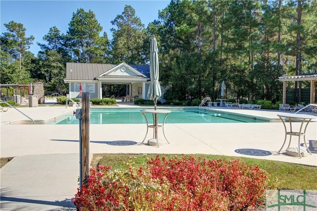 community pool featuring fence, a patio area, and a pergola