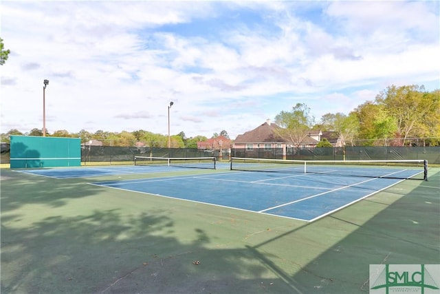 view of tennis court featuring fence