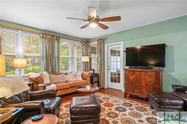 living room with a ceiling fan and wood finished floors