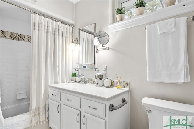 full bath featuring toilet, vanity, and shower / bath combination with curtain