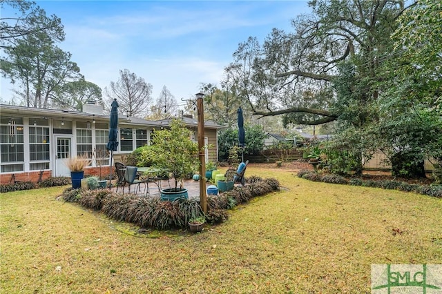 view of yard with a patio area and a sunroom