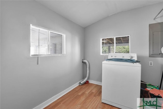 laundry area with baseboards, washer / dryer, laundry area, electric panel, and light wood-type flooring