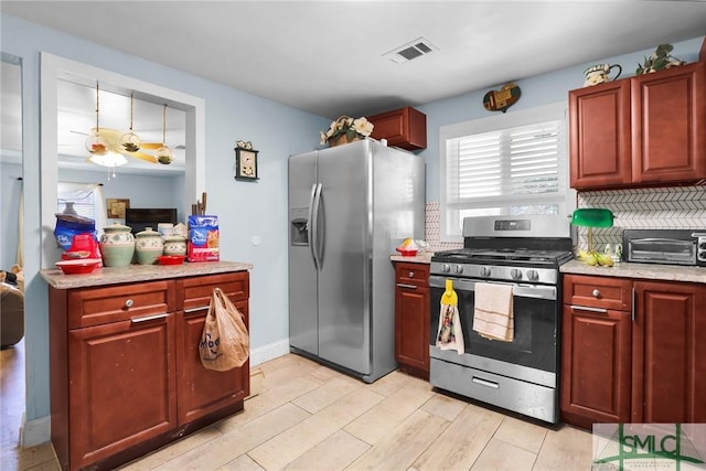 kitchen featuring visible vents, light wood-style flooring, tasteful backsplash, appliances with stainless steel finishes, and a toaster