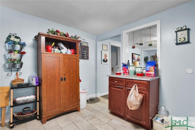 interior space featuring baseboards and light countertops