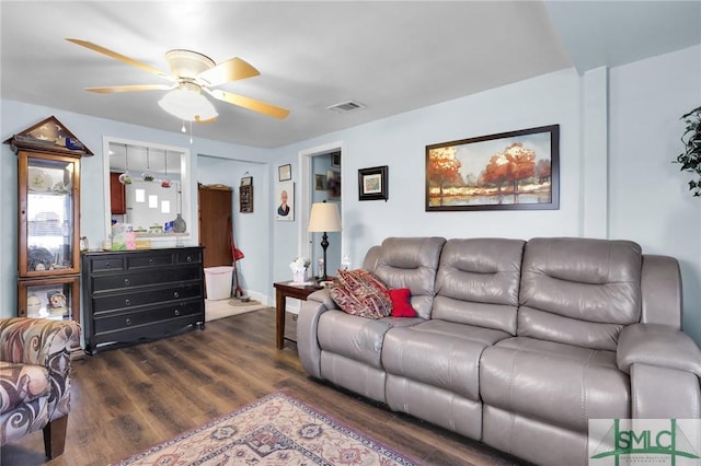 living room featuring dark wood-style floors, visible vents, and ceiling fan