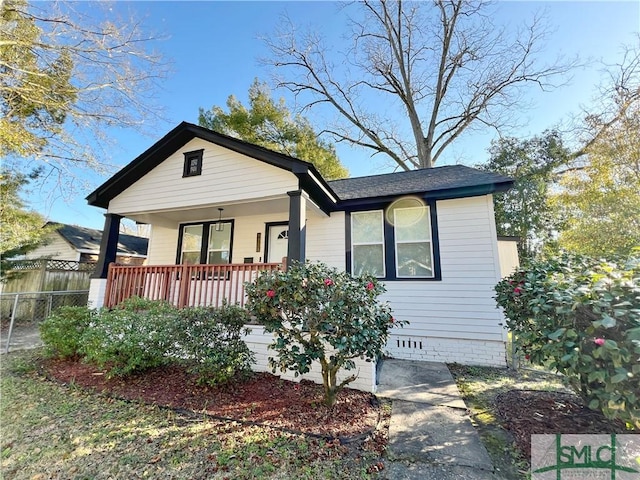 bungalow-style house with crawl space, a porch, and fence