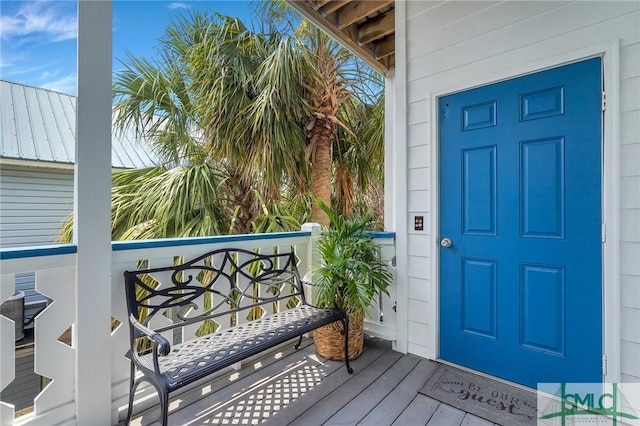 view of exterior entry with a balcony