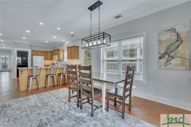 dining space with light tile patterned floors, visible vents, baseboards, recessed lighting, and ornamental molding