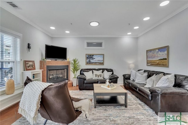 tiled living area featuring recessed lighting, visible vents, ornamental molding, and a fireplace