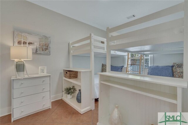 bedroom featuring tile patterned floors, visible vents, and baseboards