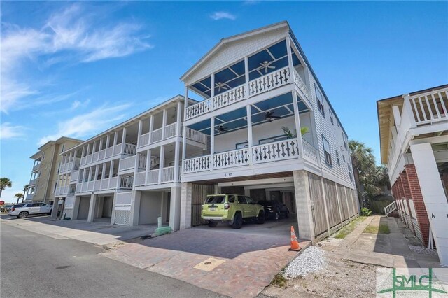 view of front of house featuring a carport and a ceiling fan